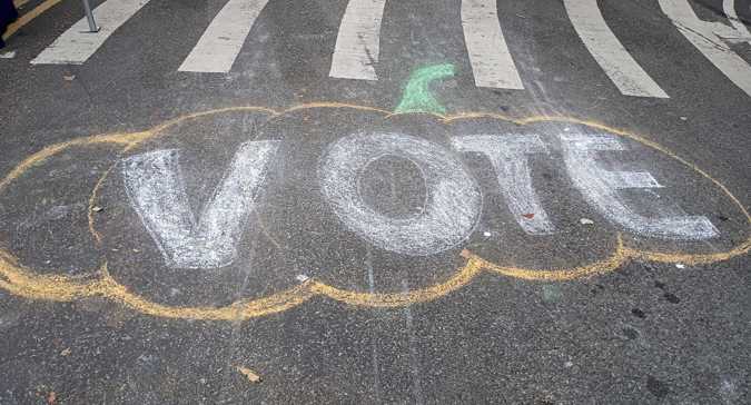 Vote written in chalk on concrete