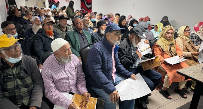 A room full of a diverse group of people 