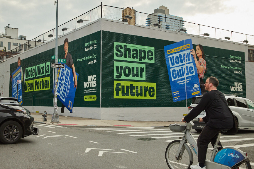 Photograph of a mural that says Shape Your Future on a street corner wall