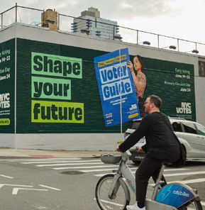 Photograph of a mural that says Shape Your Future on a street corner wall