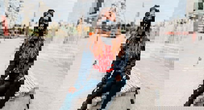 A photo of a woman wearing a mask that says vote.